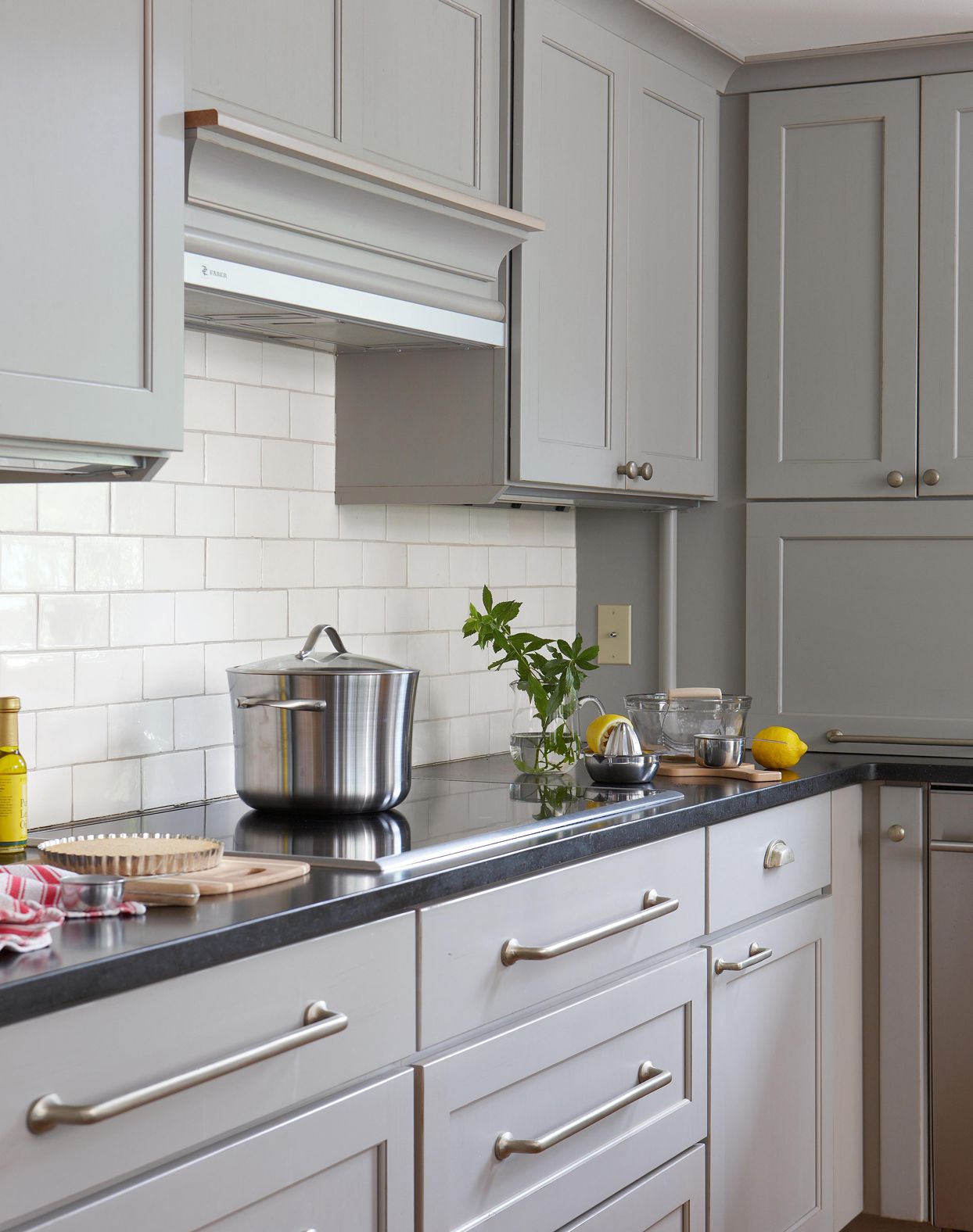 induction kitchen stove top with gray cabinets