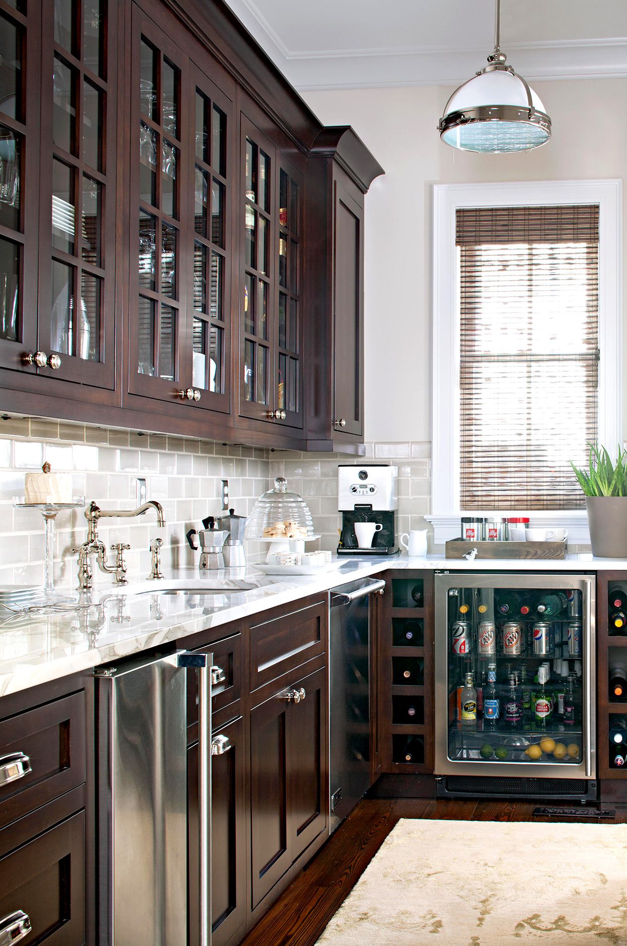 Dark wood cabinetry with light countertops with traditional style