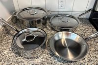 The All-Clad D3 3-Ply Stainless Steel Cookware Set on a kitchen countertop