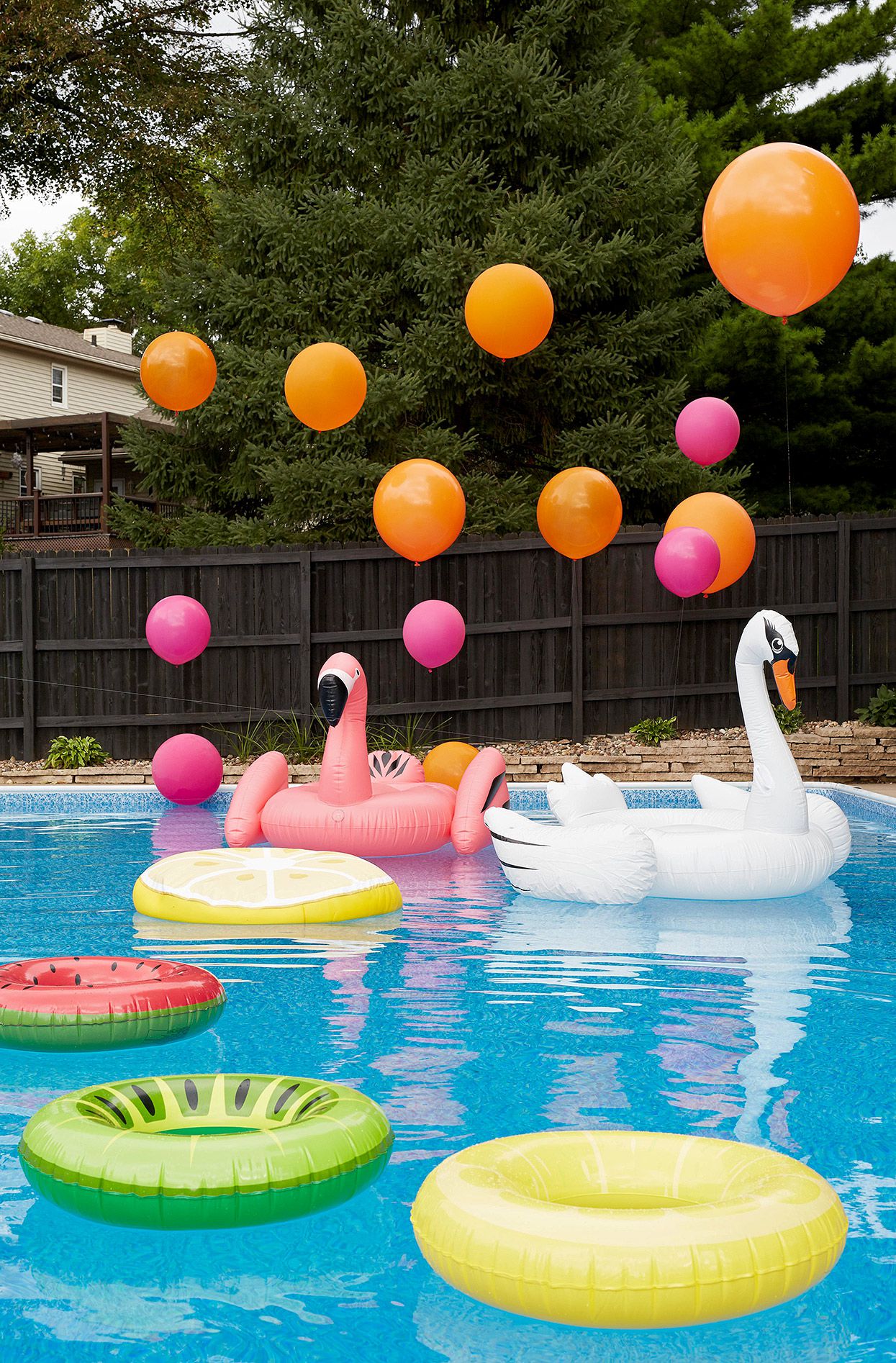pool with bright inner tubes and balloons