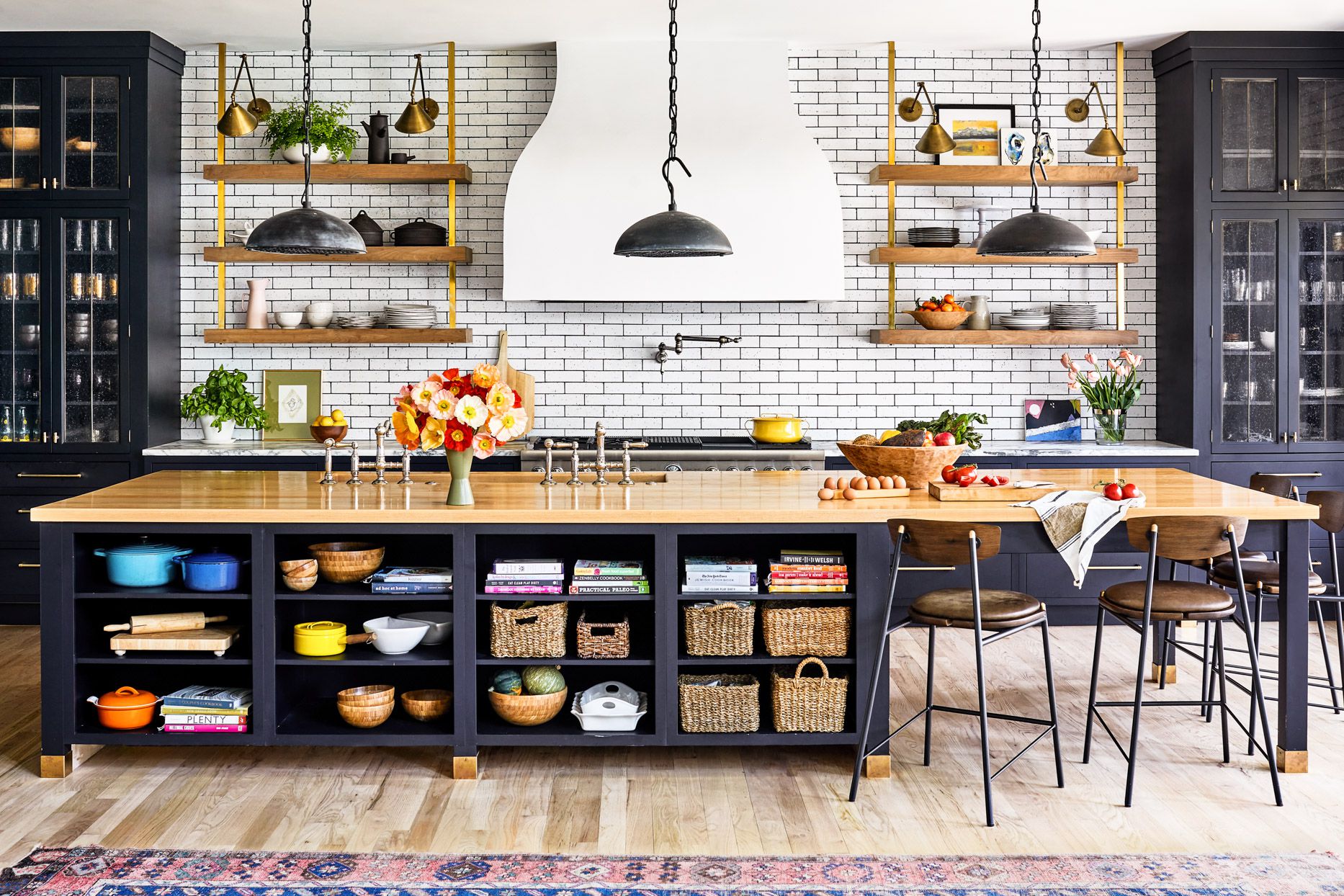 kitchen with white subway tile with wood and gold open shelves