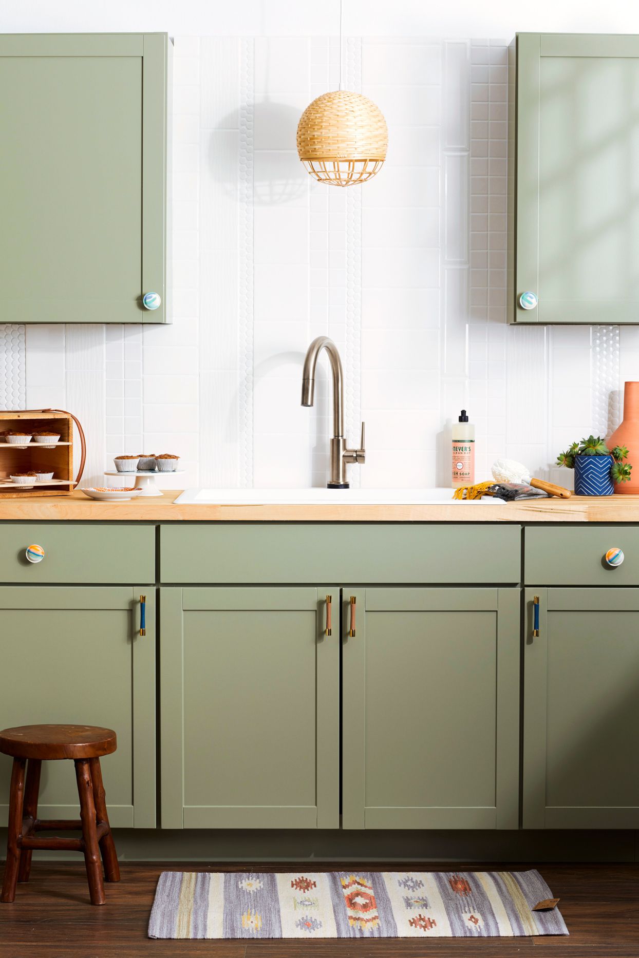 kitchen with green cabinets and white textured walls