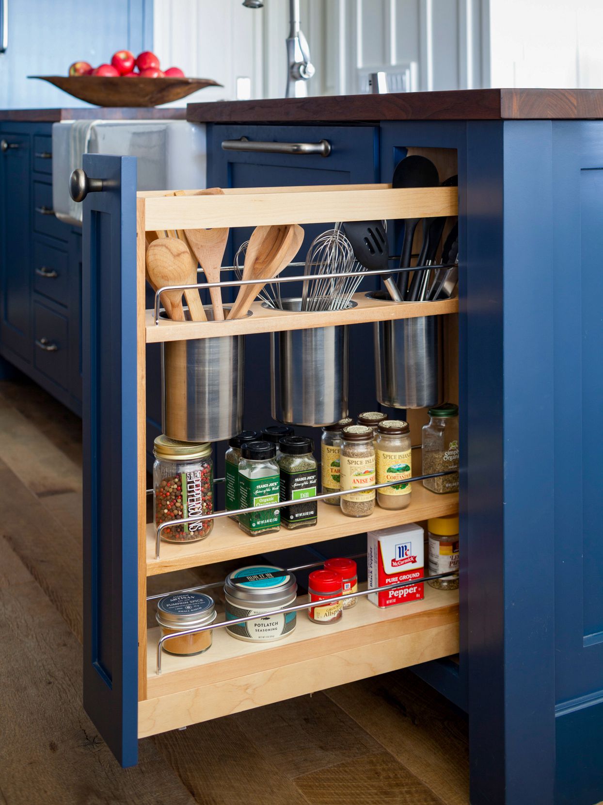 navy kitchen cabinets with roll out spice shelf
