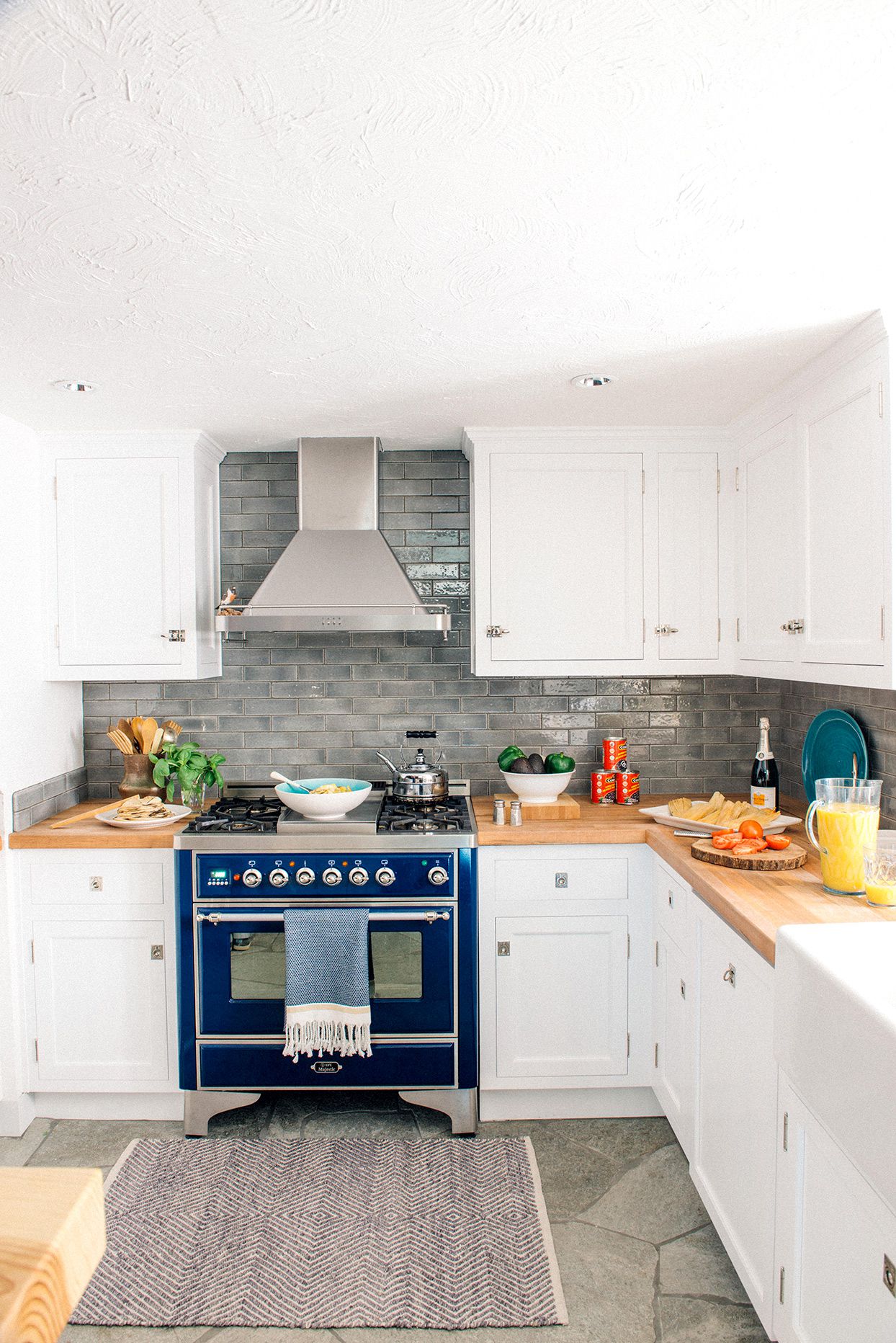 kitchen with white cabinets and blue stove