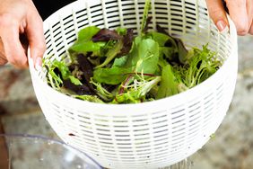 washing lettuce in colander