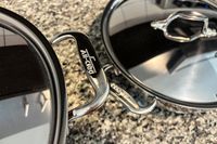 The brand name engraved on the handle of the All-Clad D3 3-Ply Stainless Steel Cookware Set