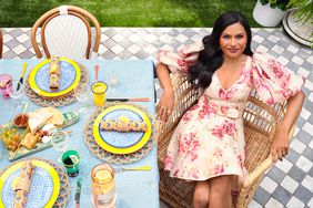 Mindy Kaling seated at outdoor decorated table