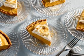 Slices of pumpkin chiffon pie on glass plates with forks nearby