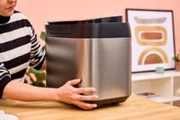 A person touches the back of the Panasonic SD-R2550 Automatic Bread Maker