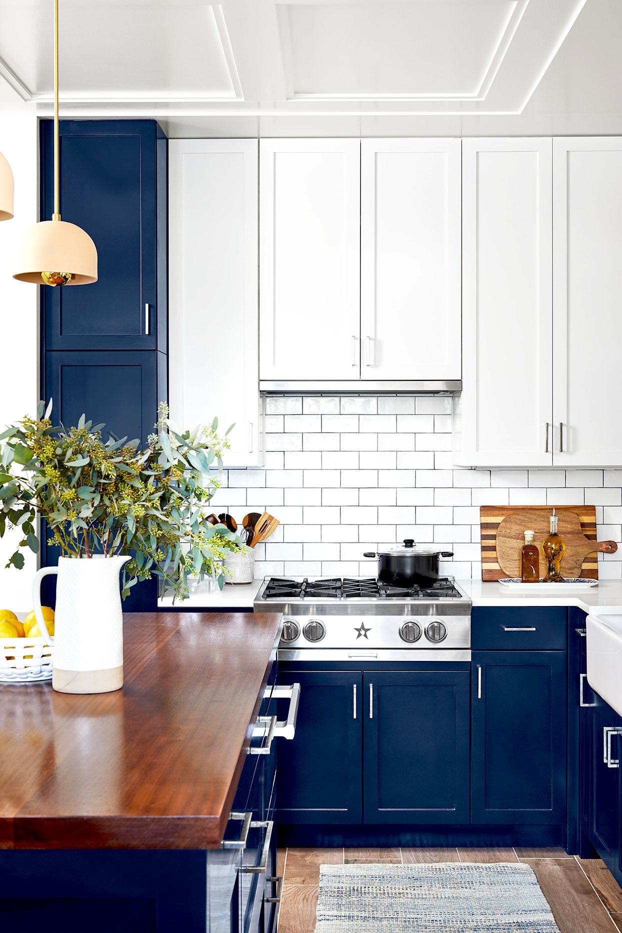 Kitchen with dark blue cabinets and white tile
