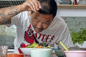 Roy Choi seasoning food at a kitchen table