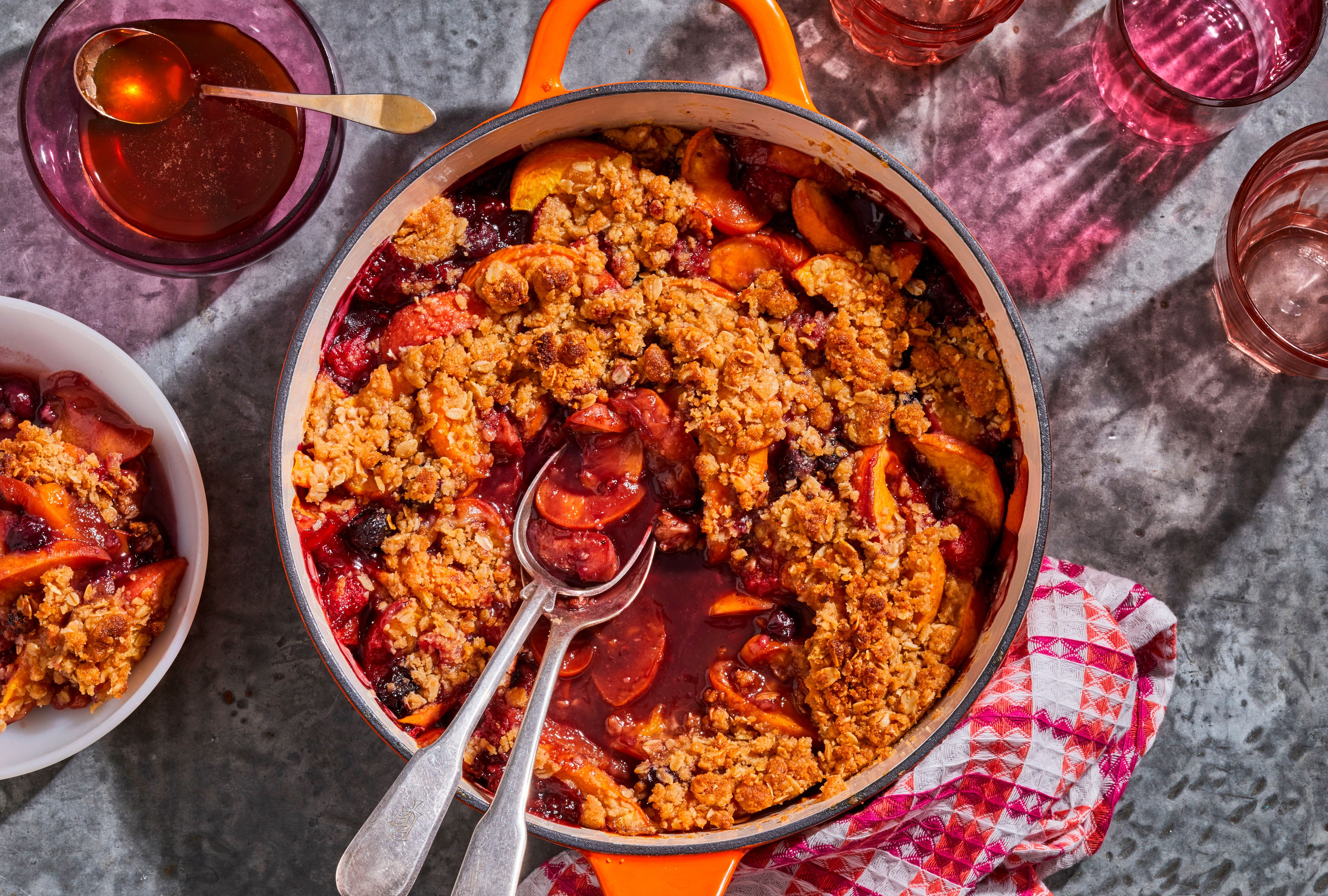 Cast iron skillet with mixed fruit cobbler on galvanized tabletop