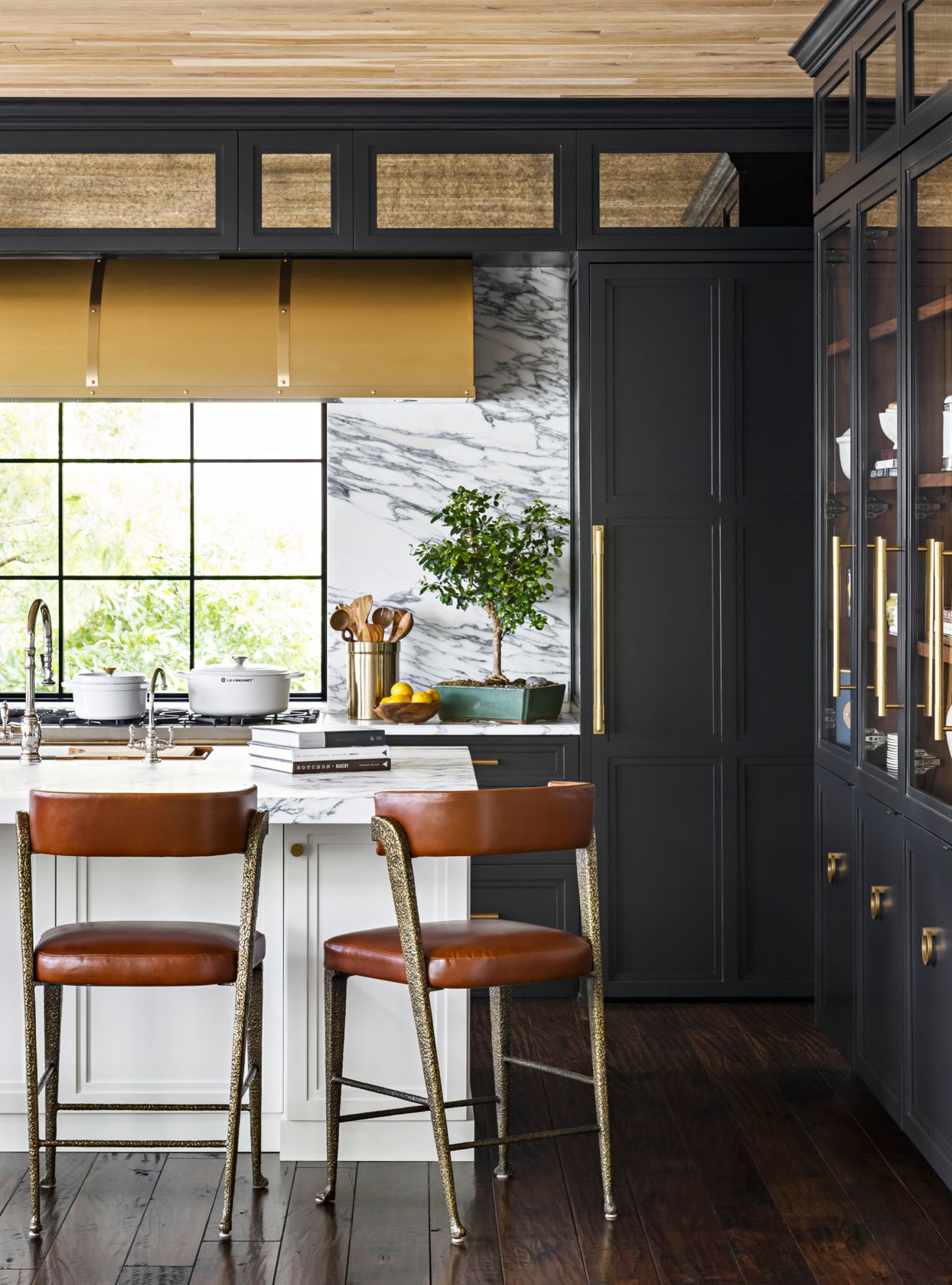 brown leather stools in dark kitchen