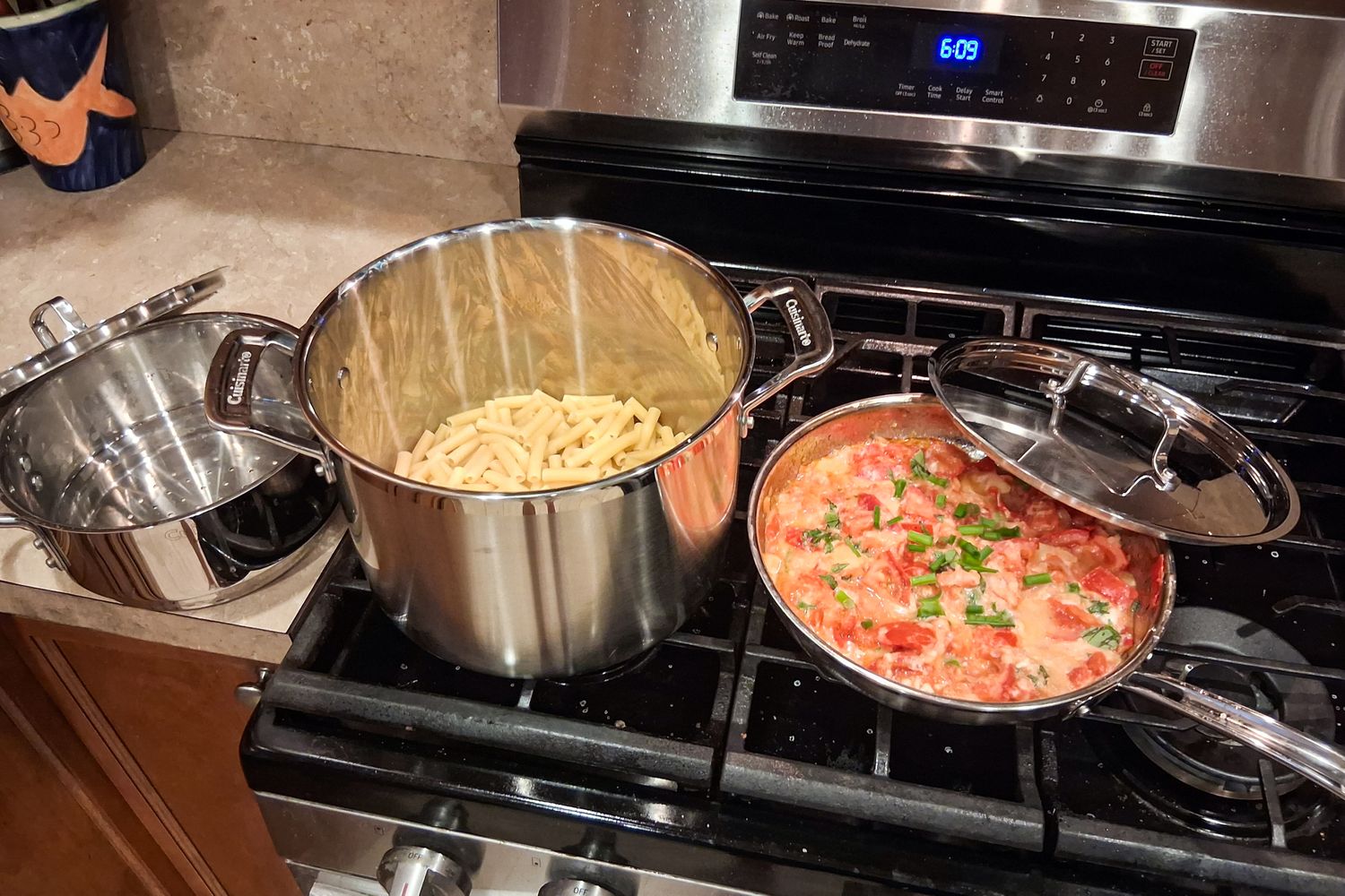 The Cuisinart MultiClad Pro 12 Piece Stainless Cookware Set on a stovetop