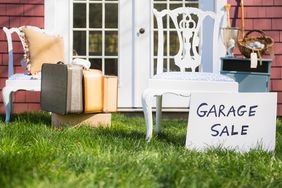 garage sale sign with items for sale on grass in front yard