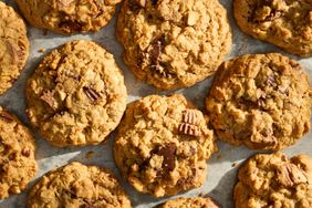 Oatmeal peanut butter cookies with chocolate chunks arranged on parchment paper