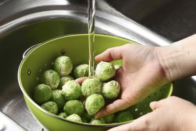 hands washing brussels sprouts
