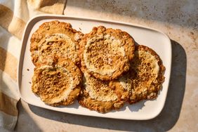 Plate of five large cookies arranged close together displayed on a light surface