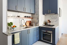 blue kitchen cabinets with gold hardware