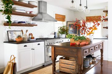 white kitchen with white tile and traditional preparation table