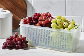 red and green grapes in a storage container