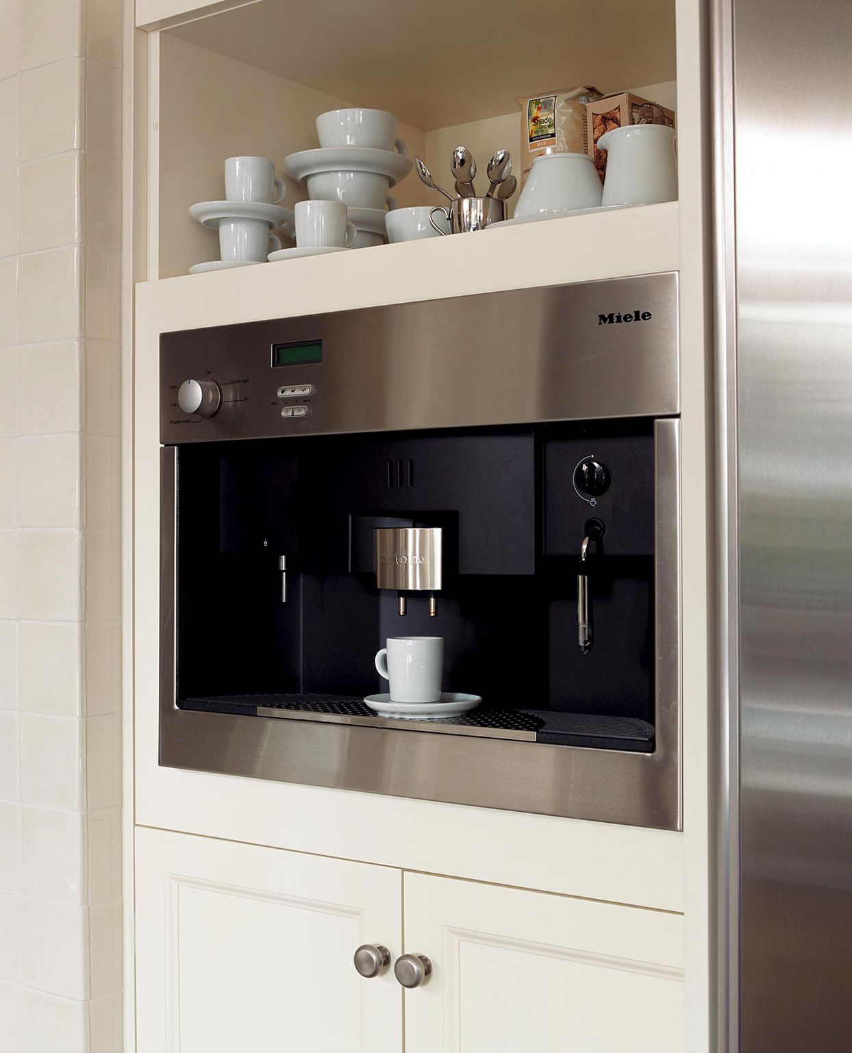 white cabinets with built in stainless steel coffee maker