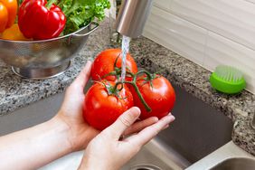 Washing tomatoes in sink