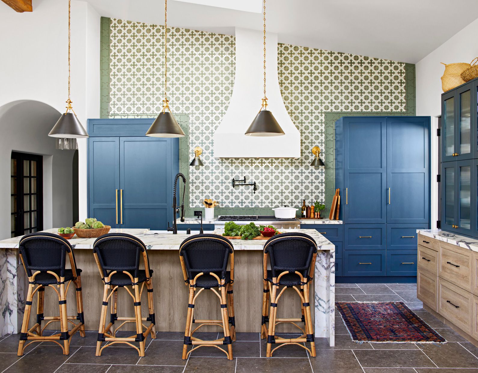 vaulted ceiling kitchen with patterned wall blue cabinets